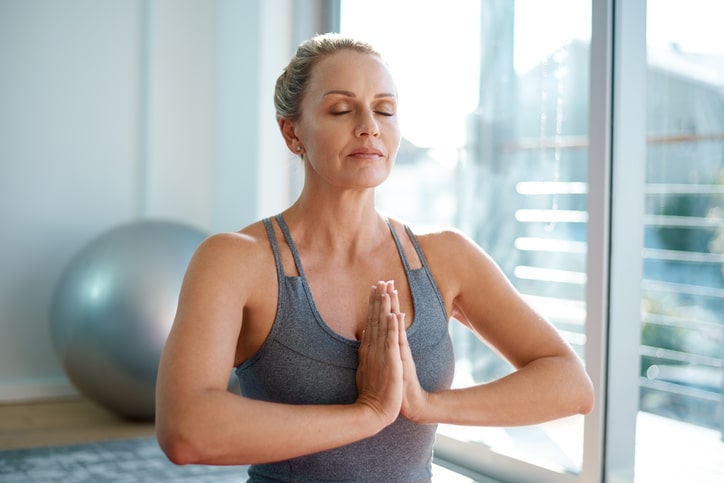 woman meditating to lower stress