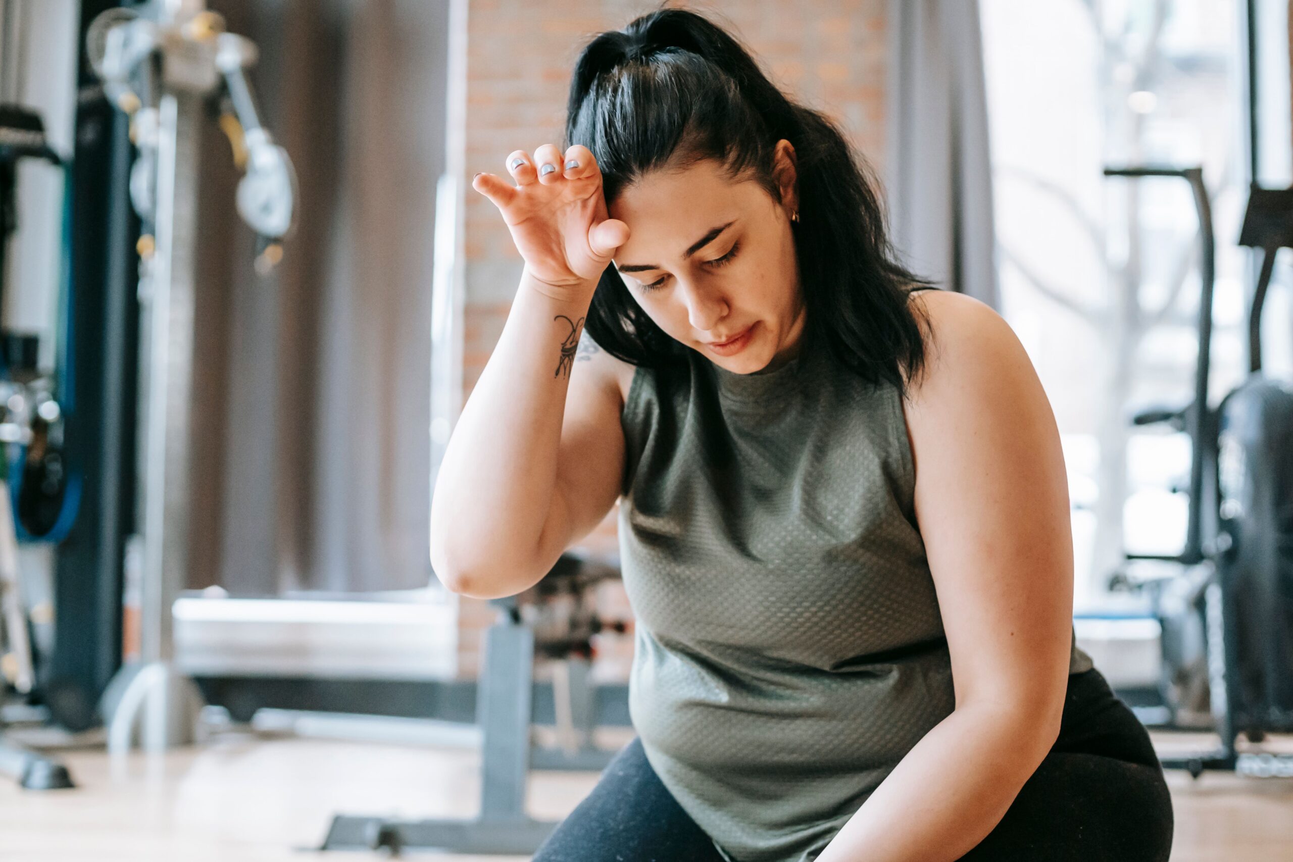 A woman at the gym, taking a break.