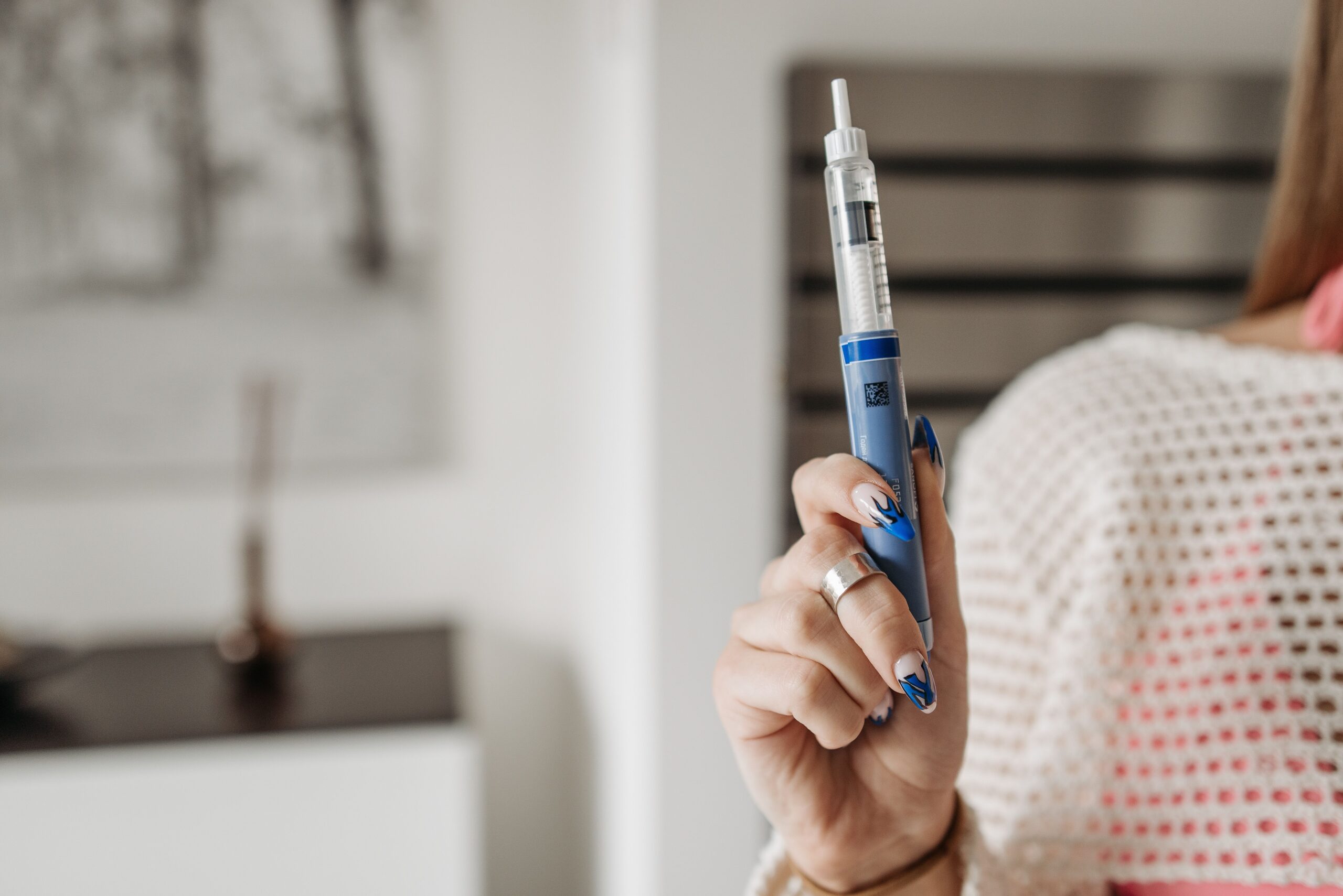 A woman holding a weight loss injection needle