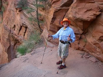 Life is good! Battista basking in glory after scaling a knife-edge ridge with huge cliffs on either side.