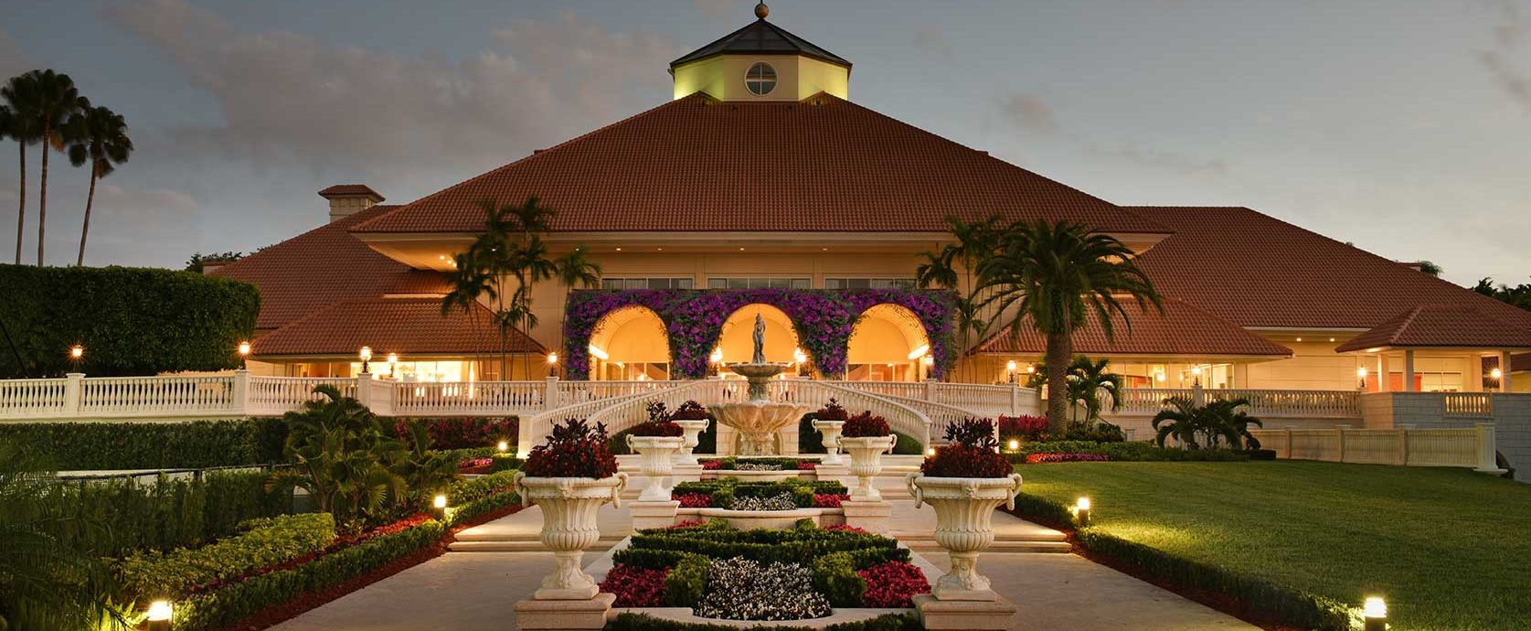 Front view of the Pritikin resort in Miami, Florida lit up at night with garden in the foreground.